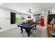 A view of the game room showcasing the pool table, bar, and natural light from the window at 2926 Boating Blvd, Kissimmee, FL 34746