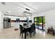Modern kitchen featuring white cabinets, stainless steel appliances, and a dining area with natural light at 2926 Boating Blvd, Kissimmee, FL 34746