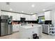 A bright white kitchen with stainless steel appliances, modern finishes, and an island at 2926 Boating Blvd, Kissimmee, FL 34746