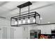 Modern lighting fixture above the dining area, with white cabinets and stainless steel appliances at 2926 Boating Blvd, Kissimmee, FL 34746