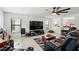 Bright and open living room with large windows, a ceiling fan, and comfortable seating at 2926 Boating Blvd, Kissimmee, FL 34746