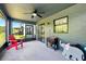 View of the screened in patio with a ceiling fan, furniture, and outdoor decor at 2926 Boating Blvd, Kissimmee, FL 34746