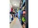 Organized walk-in closet with shelves and hanging racks for clothes and personal items at 2926 Boating Blvd, Kissimmee, FL 34746