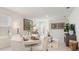 Bright dining area with modern decor, comfortable seating, and natural light from the window at 2959 Waterlily Way, Poinciana, FL 34759