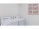 Practical laundry room with a modern washer and dryer at 2959 Waterlily Way, Poinciana, FL 34759