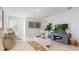 Bright living room with a TV, comfortable seating, and stylish decor, with an open layout at 2959 Waterlily Way, Poinciana, FL 34759