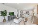 Open-concept living space with a view of the kitchen and dining area, and a large TV at 2959 Waterlily Way, Poinciana, FL 34759