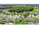 An aerial view highlighting a neighborhood with diverse home styles and mature landscaping at 2975 White Cedar Cir, Kissimmee, FL 34741