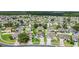Community aerial showcasing well-maintained homes with lush landscaping and mature trees at 2975 White Cedar Cir, Kissimmee, FL 34741
