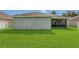 Expansive backyard with well-maintained lawn and partial view of the home's rear facade at 2975 White Cedar Cir, Kissimmee, FL 34741