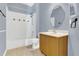 This light blue bathroom features a tub and shower combo and a single vanity at 2975 White Cedar Cir, Kissimmee, FL 34741