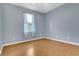 A light-filled bedroom with natural light, hardwood floors, and neutral walls at 2975 White Cedar Cir, Kissimmee, FL 34741