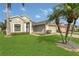 Well-maintained home featuring a lush green lawn and a convenient two-car garage at 2975 White Cedar Cir, Kissimmee, FL 34741