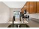 Cozy kitchen with stainless steel appliances, dark countertops, and tile flooring at 2975 White Cedar Cir, Kissimmee, FL 34741