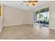 Open-concept living area featuring tile flooring, a ceiling fan, and sliding door access to the lanai at 2975 White Cedar Cir, Kissimmee, FL 34741