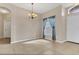 Inviting space with tile flooring, chandelier, a window dressed with decorative curtains at 2975 White Cedar Cir, Kissimmee, FL 34741