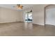 Bright living area features tile flooring, a ceiling fan, and sliding door access at 2975 White Cedar Cir, Kissimmee, FL 34741