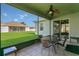 Enjoy the outdoors in a screened-in patio with a ceiling fan and comfortable seating at 2975 White Cedar Cir, Kissimmee, FL 34741