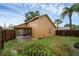 Cozy backyard features a screened lanai, privacy fence, and mature landscaping at 311 Lakebreeze Cir, Lake Mary, FL 32746
