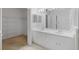 Bright bathroom featuring double sinks, white cabinetry, and a spacious walk-in closet for ample storage at 311 Lakebreeze Cir, Lake Mary, FL 32746