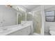Bathroom featuring a double vanity, a glass-enclosed shower, and a modern toilet for added convenience at 311 Lakebreeze Cir, Lake Mary, FL 32746