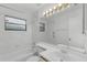 Bathroom with bathtub, shower, and vanity; featuring updated fixtures and modern design elements at 311 Lakebreeze Cir, Lake Mary, FL 32746