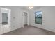 Well-lit bedroom with carpet, a closet, and a large window with neighborhood views at 311 Lakebreeze Cir, Lake Mary, FL 32746