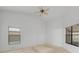Bright bedroom featuring carpeted floors, ceiling fan, and large windows allowing for natural light at 311 Lakebreeze Cir, Lake Mary, FL 32746