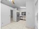 Open-concept kitchen with stainless steel refrigerator and view to living area at 311 Lakebreeze Cir, Lake Mary, FL 32746