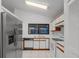 Well-lit kitchen showcasing stainless steel refrigerator, white cabinetry, and tile flooring at 311 Lakebreeze Cir, Lake Mary, FL 32746