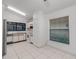 Bright kitchen features white cabinetry, tile flooring, and modern appliances perfect for cooking at 311 Lakebreeze Cir, Lake Mary, FL 32746