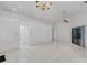 Spacious living area featuring tile floors, ceiling fan, and sliding glass doors to the lanai at 311 Lakebreeze Cir, Lake Mary, FL 32746