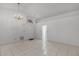 Open living room with tile flooring, chandelier, and arched window above the front door at 311 Lakebreeze Cir, Lake Mary, FL 32746