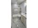 Well-lit bathroom featuring a bathtub/shower combination, vanity and marble-like tiling at 3146 Byington Terrace Ter, Deltona, FL 32738