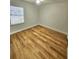 This bedroom features wood-look flooring, large window, and modern ceiling fan at 3146 Byington Terrace Ter, Deltona, FL 32738