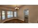 Dining room features a bay window overlooking the pool, wood floors and modern light fixture at 3146 Byington Terrace Ter, Deltona, FL 32738