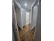 Hallway features wood-look flooring and leads to bedrooms and bathroom at 3146 Byington Terrace Ter, Deltona, FL 32738