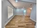 Open living area with wood-look floors, large window, and recessed lighting at 3146 Byington Terrace Ter, Deltona, FL 32738