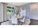 Bright dining area features a modern pendant light fixture, a view to the outdoors, and stylish decor at 3361 Orange Rose Loop, Apopka, FL 32712
