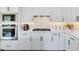 Close-up of kitchen with white cabinets, stainless steel appliances, and marble backsplash at 3361 Orange Rose Loop, Apopka, FL 32712