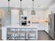 Beautiful kitchen boasts white cabinetry, stainless steel appliances, and an island with seating at 3361 Orange Rose Loop, Apopka, FL 32712