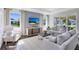 Elegant living room featuring modern decor, a light gray accent wall, and hardwood flooring at 3361 Orange Rose Loop, Apopka, FL 32712