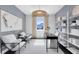 Bright home office with modern decor, decorative shelving, and comfortable seating areas at 3361 Orange Rose Loop, Apopka, FL 32712