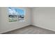 An empty bedroom featuring carpet, neutral walls and a large window with a neighborhood view at 3723 Bluethread Way, Poinciana, FL 34759