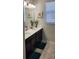Bright bathroom with double vanity, decorative starfish art, and plush blue rugs at 3986 Bedford Ave, Winter Haven, FL 33884