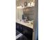 Bathroom with double sinks, dark cabinets, quartz countertop, and large mirror at 3986 Bedford Ave, Winter Haven, FL 33884
