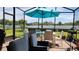 Covered lanai with dining set for outdoor enjoyment in a private fenced backyard at 3986 Bedford Ave, Winter Haven, FL 33884