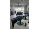 Open living room with sliding glass doors leading to a screened patio and lake view at 3986 Bedford Ave, Winter Haven, FL 33884
