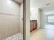 Bathroom featuring a tiled shower with decorative accent tiles and brown vanity at 404 Wilshire Dr, Casselberry, FL 32707