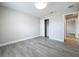 Bedroom with wood-look floors, fresh paint, closet, and natural light at 404 Wilshire Dr, Casselberry, FL 32707